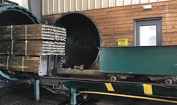 Preserve treated wood coming out of the cylinder Preserve treated wood coming out of the cylinder